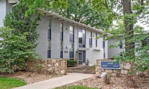 a building with a sign and trees