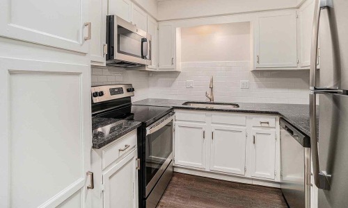 a kitchen with white cabinets