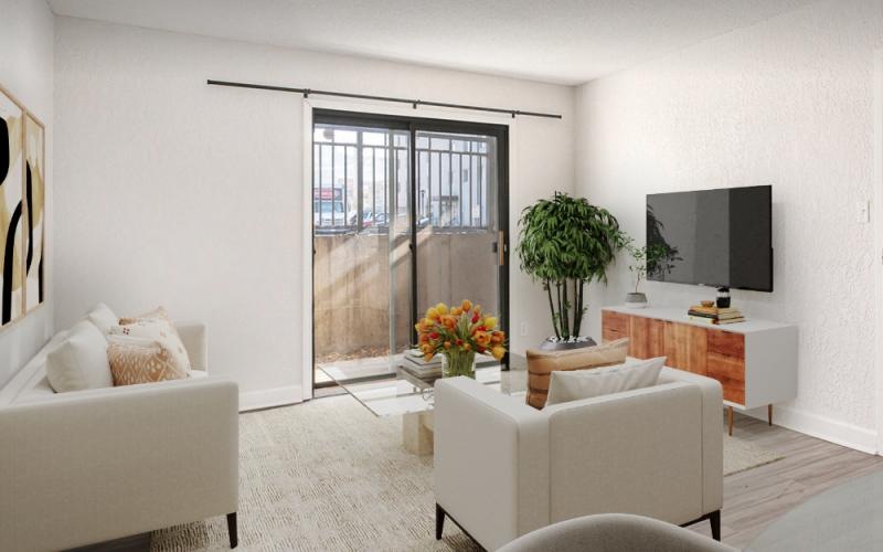 a living room with a glass door and couch and tv