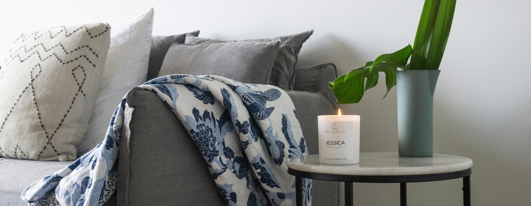 a couch with a coffee table and a plant on it