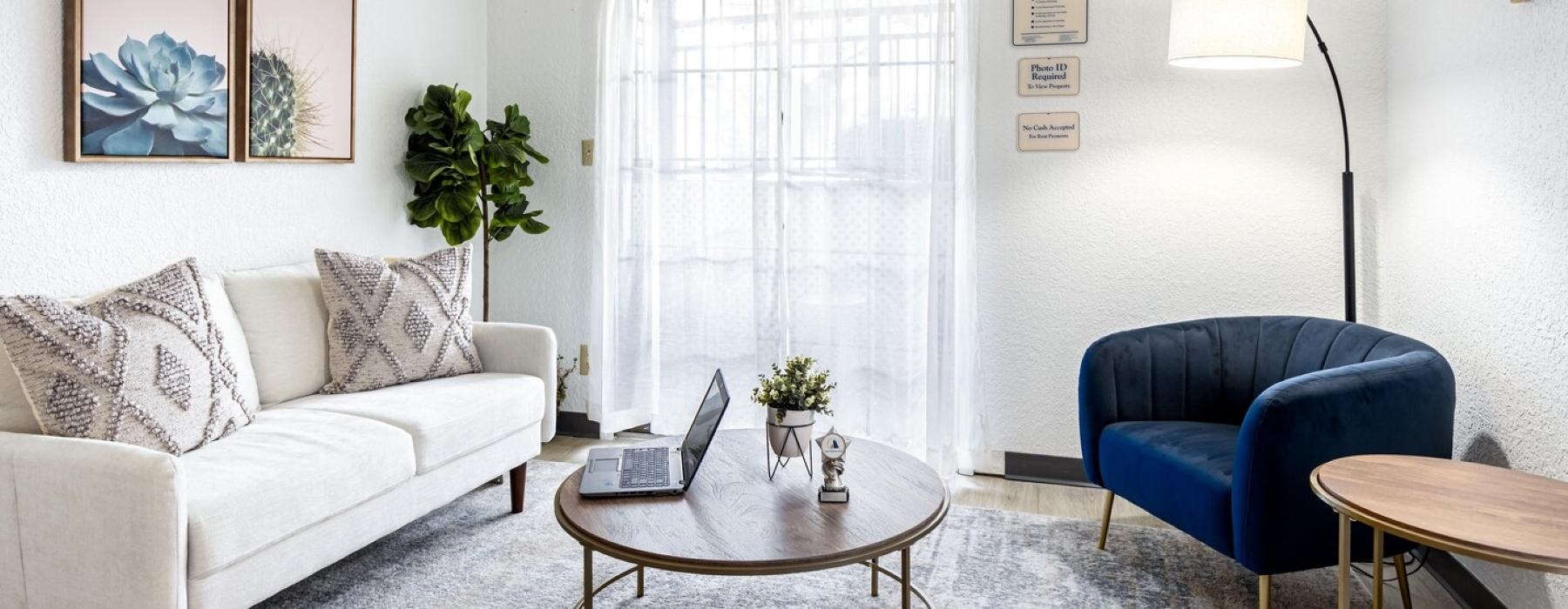 a living room with a couch and a table and large window