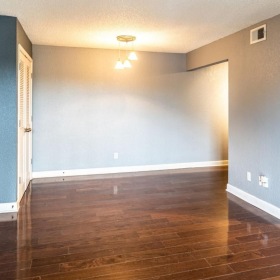 a room with a wood floor and white doors
